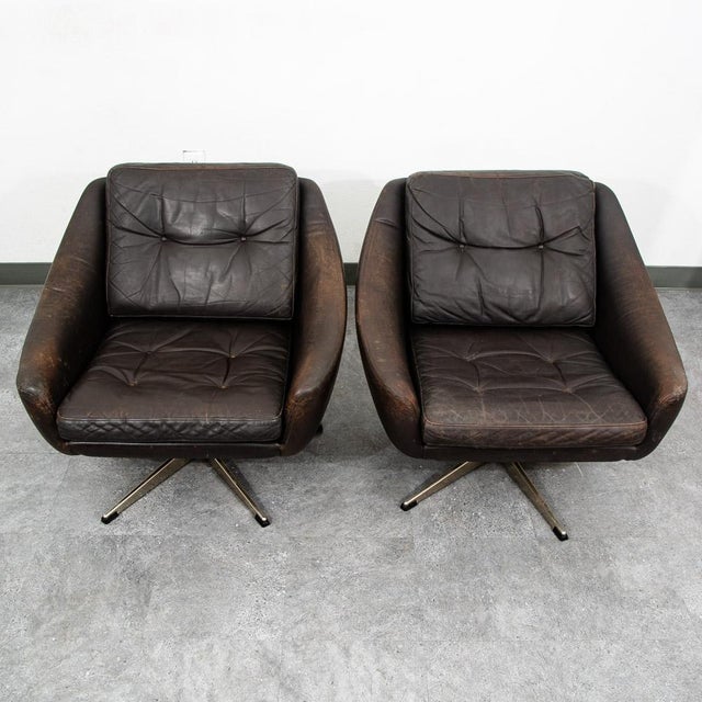 Pair of dark brown leather swivel chairs by unknown Danish designer. Original soft leather chair set on a swiveling metal...