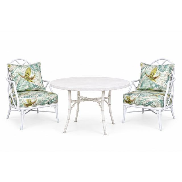 A refined outdoor dining table by Michael Taylor conceived with a sculptural bamboo-inspired metal base and a circular...