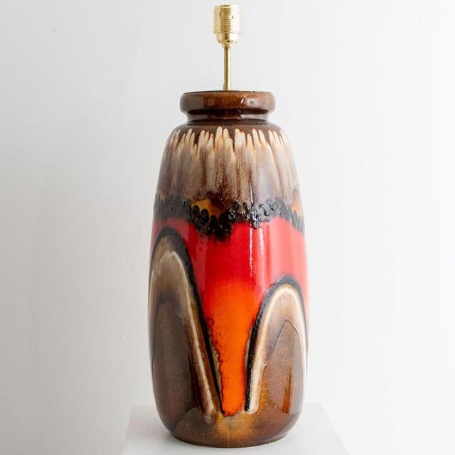 Fat Lava' style ceramic table lamp with brown with red and orange glaze. Manufactured in West-Germany in the 1970's. The...