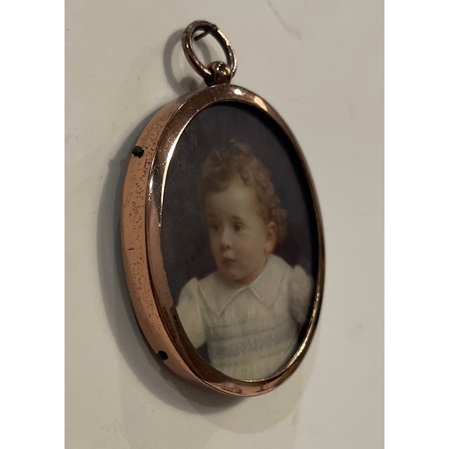 Antique portrait miniature of a boy, inscribed on the back illegibly with either the artist's name or the sitter....