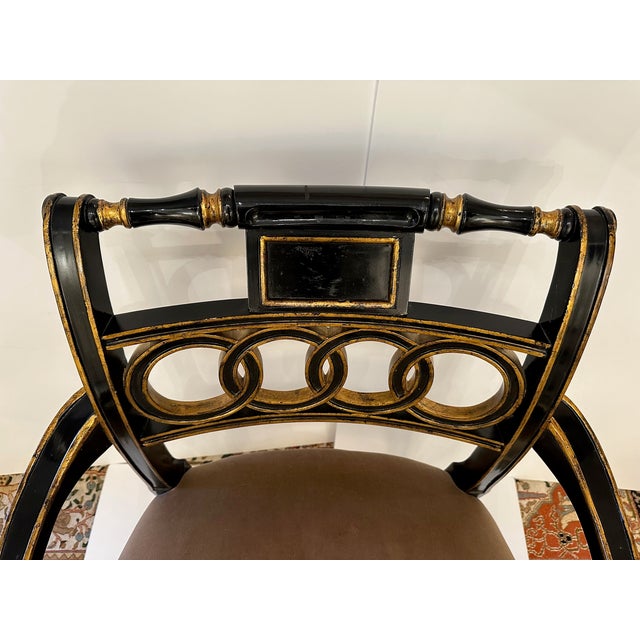Glamorous Hollywood Regency style armchair in black and gold with elegant taupe velvet seat. Arm. 26.5” H Seat. 19” D x 19” H