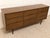 A beautifully streamlined vintage dresser with a long, low silhouette and warm walnut finish. The nine-drawer layout gives...