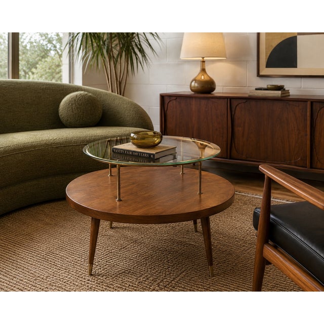 Elegant mid-century modern cocktail table by James-Philip Co. of Paterson, New Jersey, featuring a suspended circular...