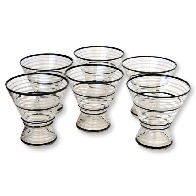 Set of six 1950s cocktail glasses. They have an interesting look when full as the bases are hollow. No maker's marks.