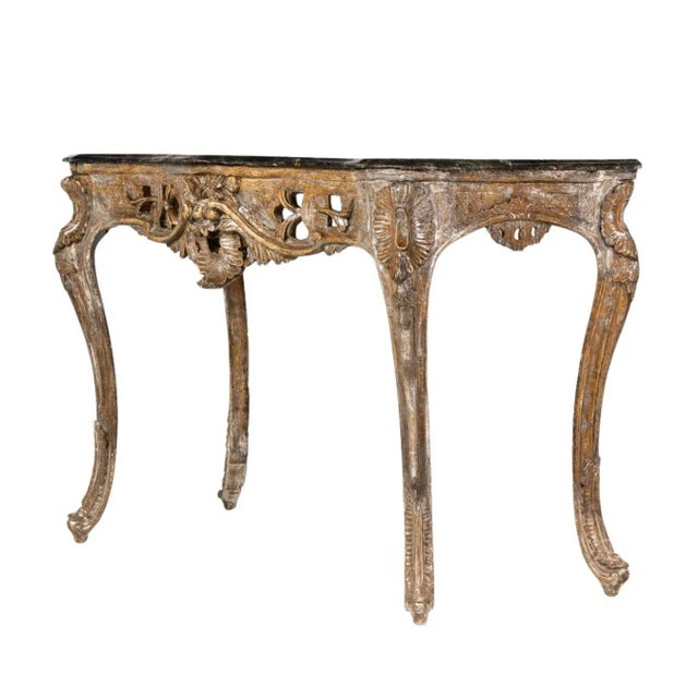 This early 18th-century Italian Rococo table boasts a stunning silver gilt finish, achieved through a blend of silvering...