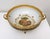 An elegant antique porcelain and gilt bronze centerpiece bowl featuring a finely hand-painted romantic courting scene,...