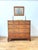 A stunning 18th century varnished fruitwood set of drawers, in a two over three drawer arrangement, with traditional brass...