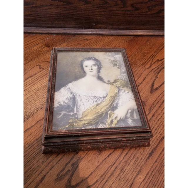 antique jewelry box w/ antiqued mirror and storage compartments inside. wood frame with glass covered portrait of woman on...