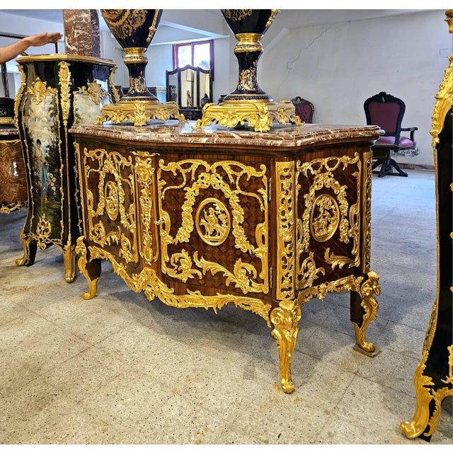 An extraordinary Louis XV style sideboard cabinet showcasing exceptional craftsmanship and lavish ornamentation...