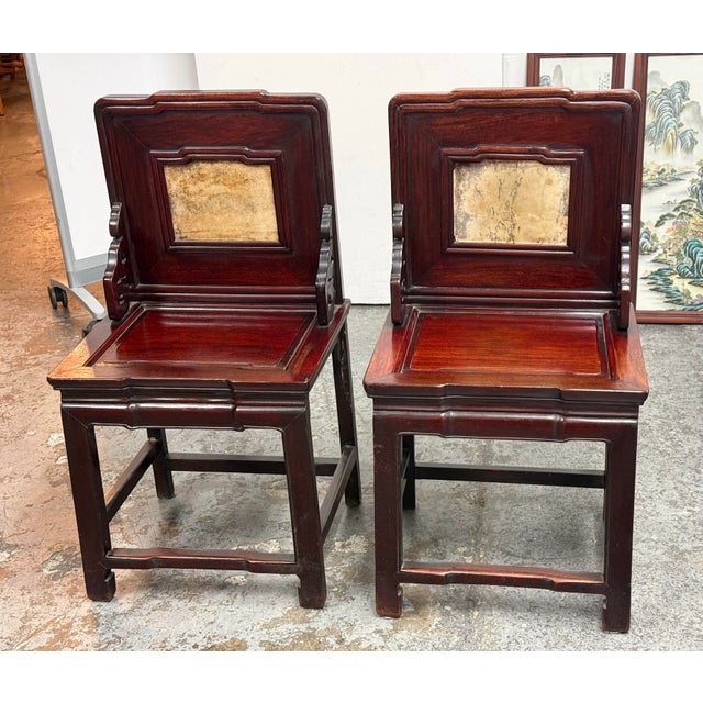 Design Plus Gallery presents a Pair of Antique Chinese Rosewood Side Chairs + Stone Inserts. These traditional Chinese...
