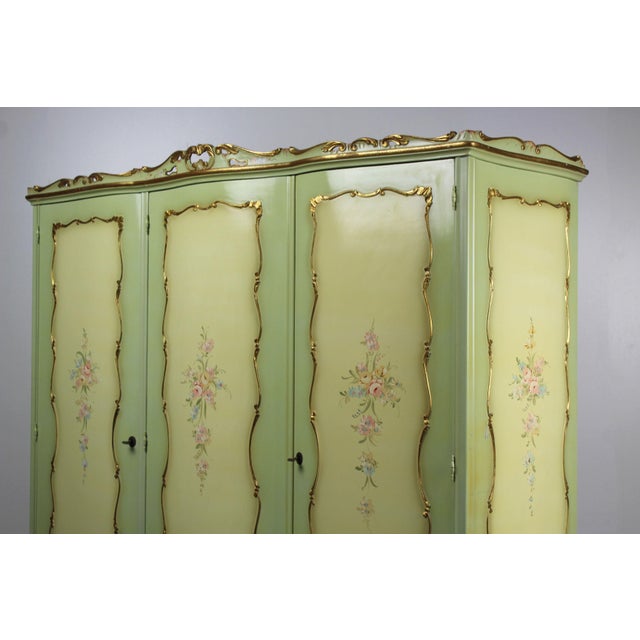 A romantic and practical mid-20th century Venetian Baroque-style wardrobe, finished in luxurious green lacquer with hand-...