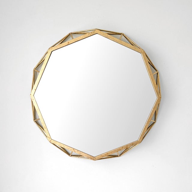 Contemporary wall hanging octagonal mirror with open-work gold frame.
