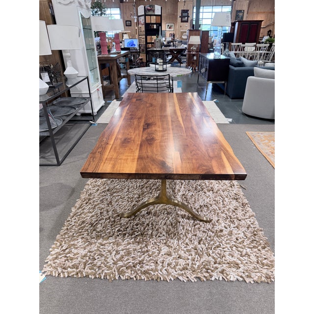 A striking dining table that blends organic craftsmanship with contemporary design. The expansive live edge walnut top...