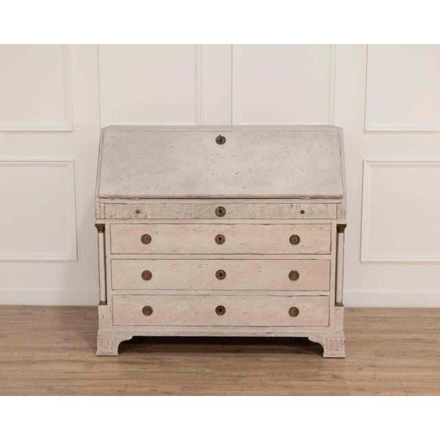 This refined 19th-century Swedish bureau is distinguished by its architectural presence, elegant carvings, and beautifully...