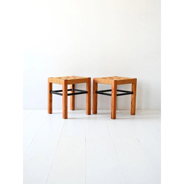 Pair of mid-century Scandinavian stools in lacquered pine, with black structural details and a durable ochre woven fabric...
