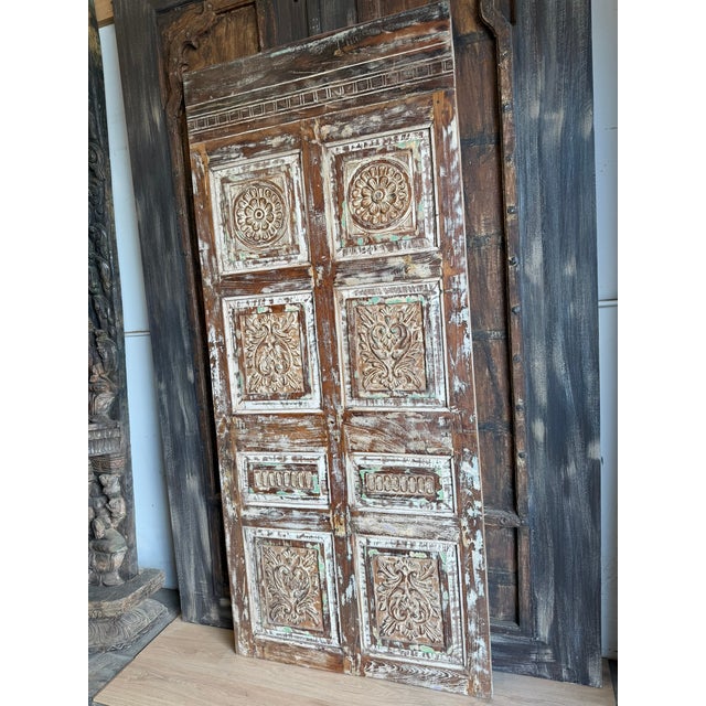 A striking architectural statement piece with serious character. This single barn door showcases hand-carved detailing...