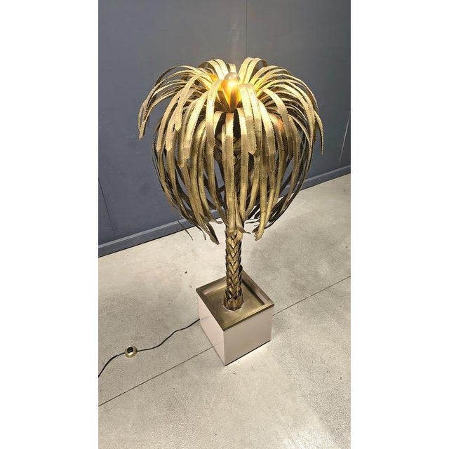 Impressive vintage torch cut brass palm tree floor lamp. Beautifully detailed leafs and tree trunk. The lamp emits a...