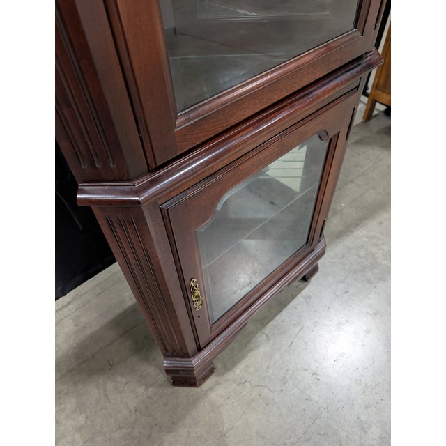 Crafted by the renowned Jasper Cabinet Company, this elegant corner display cabinet showcases timeless craftsmanship and...