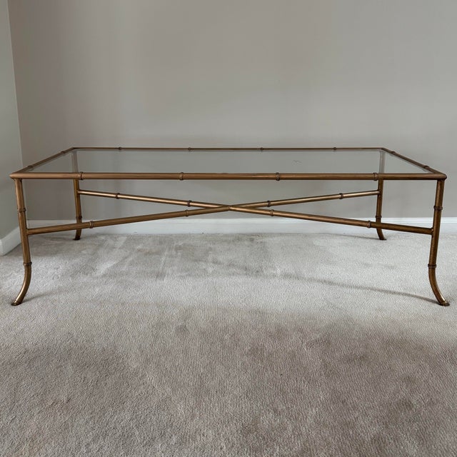 Fabulous vintage Italian Hollywood Regency style faux bamboo gilt metal coffee table with glass top inset. Measures 48” w...