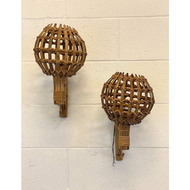 Pair of 1970s rattan and bamboo wall sconces. European Plug (up to 250V).The wiring of this item may be original and might...