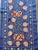 Hand-embroidered Suzani table runner from Uzbekistan — peach pomegranates and crimson tulip blossoms on a periwinkle blue...