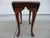 A traditional, oval, Queen Anne style, mahogany, drop-leaf side table, made in the United States, and attributed to...
