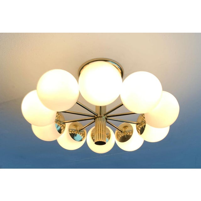 Imposing ceiling or wall light from Kaiser shine. The shiny brass surface gives this design a high -quality appearance....