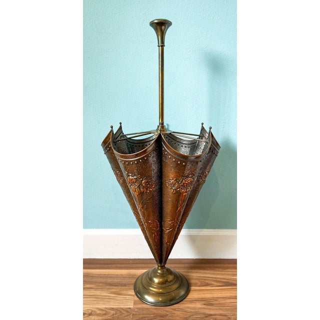 Stunning, vintage umbrella stand with a figural umbrella made of copper on a brass stand. It features a lovely embossed...
