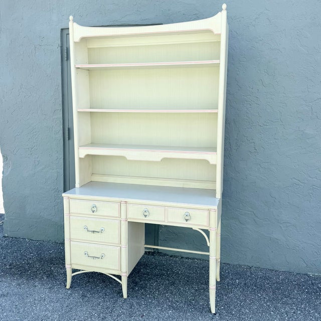 Desk: 46.25”w, 18”d, 30.25”h Hutch: 46.25”w, 10.25”d, 52.5”h A charming vintage Thomasville desk and hutch featuring faux...