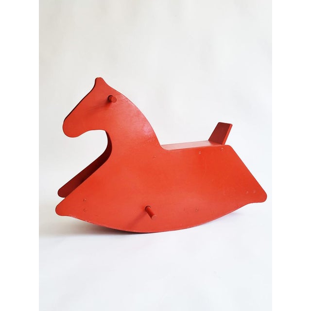 Made from cherry red lacquered plywood, this decorative mid-century rocking horse is equally at home in a stylish living...