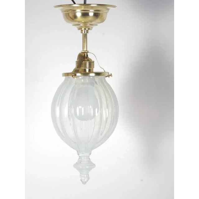 Restored brass lamp with hand blown milky glass shade. Height is 35 cm, diameter is 13 cm. Light discoloring to the edges...