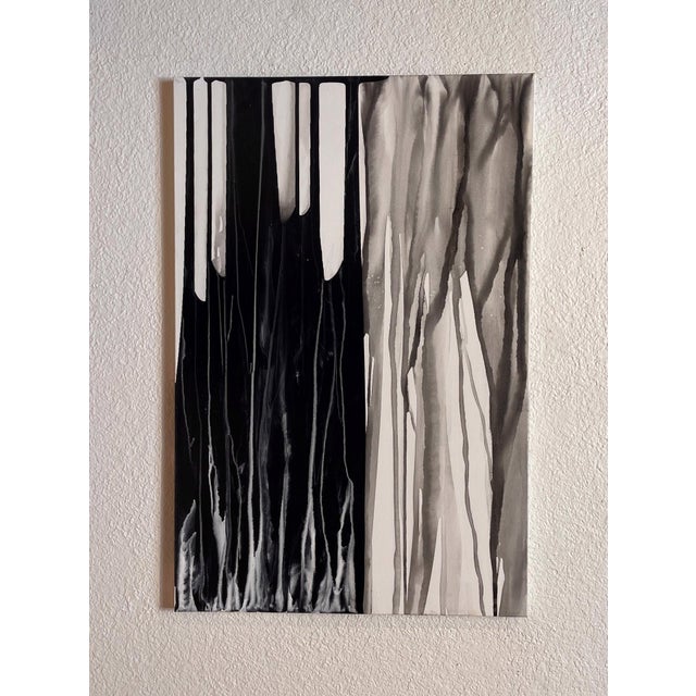 Southern Sea features a dynamic interplay of black and white ink that evokes the rhythmic movement of water and the...