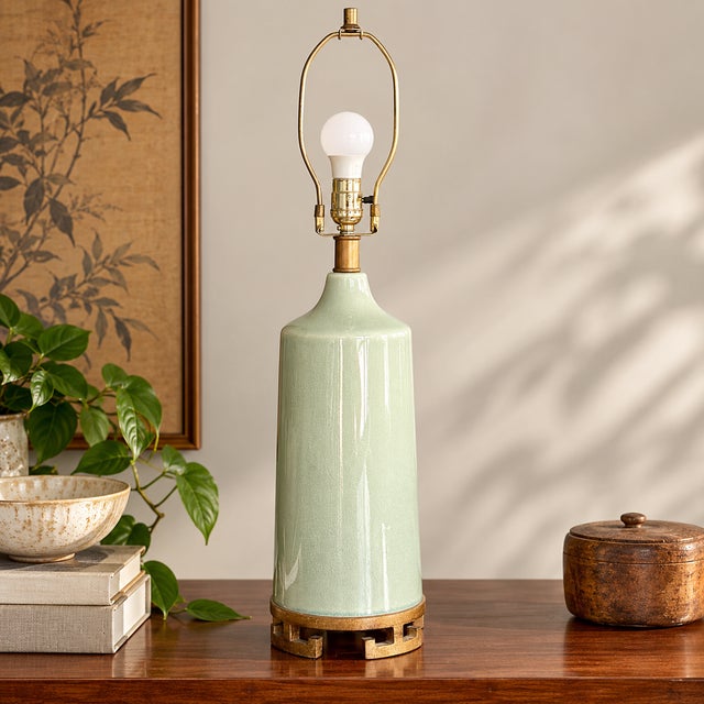 Elegant vintage Mid-Century table lamp featuring a tall, gently tapered ceramic body finished in a luminous pale celadon...