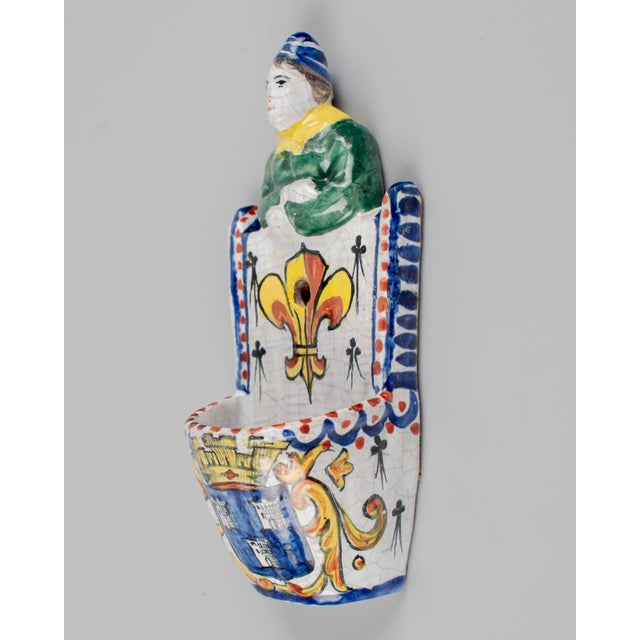 A 19th century French faience wall pocket, or a bénitier, or holy water font, used for blessings upon entering or leaving...