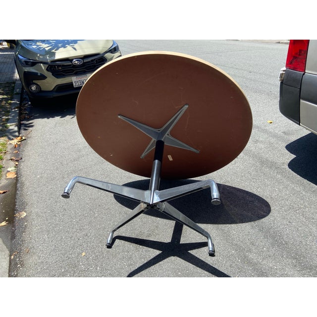 The Mcm Eames Herman Miller Round Table 48" is an antique conference table with an oval shape and brown color. Made of...