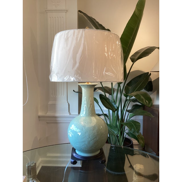 A striking vintage celadon porcelain table lamp featuring an elegant bottle-form silhouette with finely molded dragon and...