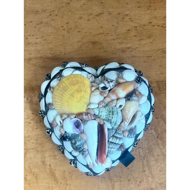 This vintage trinket box is built in a heart-shaped silhouette and lavishly encrusted with a curated mosaic of natural...