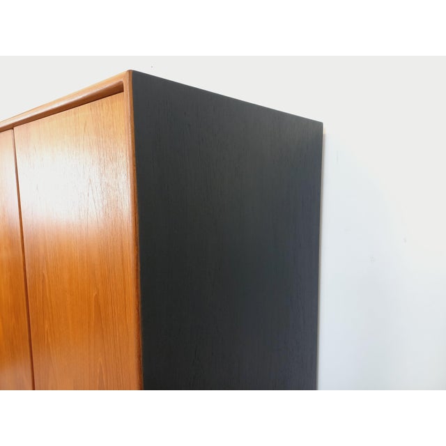 Vintage Scandinavian modernist style wardrobe from the 1960s, stamped “RT Mobel”, made of teak with black wood sides and...