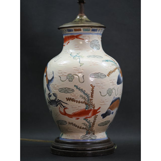 Chinese porcelain table lamp in the famille rose style featuring a vase body painted with images of various aquatic life,...
