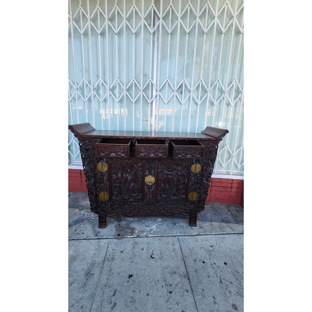 ntricately carved wooden altar cabinet is finished in a dark Rosewood stain. This piece has three top drawers and a large...