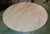 A mid-century pale pink round Italian marble top is set on an octagonal wood pedestal base, painted cream with gold trim....
