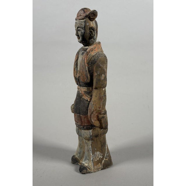 Sculpture of a Mingqi Servant with Removable Head, China, Tang Dynasty (618-907). Terracotta sculpture painted with a...