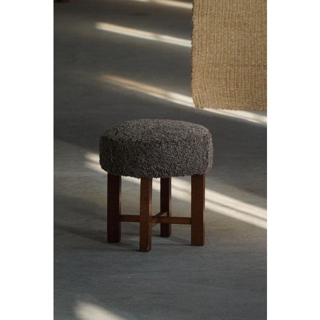 A sculptural and charming Danish Modern stool from the 1960s, crafted in solid oak and newly reupholstered in high-quality...