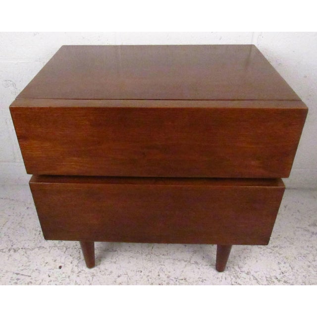 Vintage-modern nightstand, features two drawers and rich walnut grain throughout. Please confirm item location NY or NJ...
