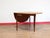 Elevate your dining space with this stunning drop leaf dining table. Expertly crafted by renowned British furniture in the...