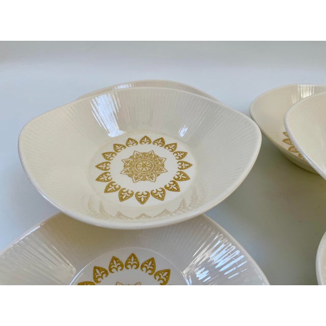 Midcentury vintage ivory-colored dinner bows with center gold sunburst medallion motif. Unmarked and in excellent vintage...