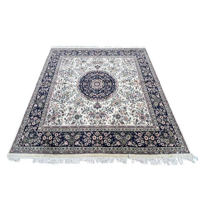 Persian Tabriz square rug, hand knotted in Pakistan from 100% wool. Measuring 8’ x 8’, the rug features an elegant central...