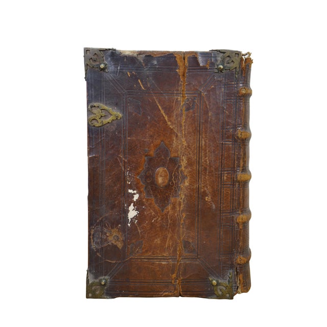 An 18th Century Dutch Folio Bible With New & Old Testament. Features a thick leather bound exterior with tooled leather,...