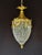 A refined 1970 French Louis XVI style bronze and crystal lantern chandelier, made in Europe and designed with a warm gold...