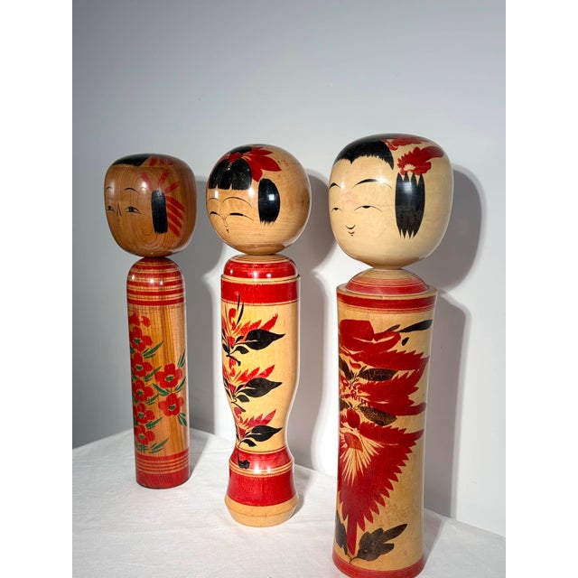 A rare set of three monumental traditional japanese turned wooden dolls, known as kokeshi dentō. Originating from the...